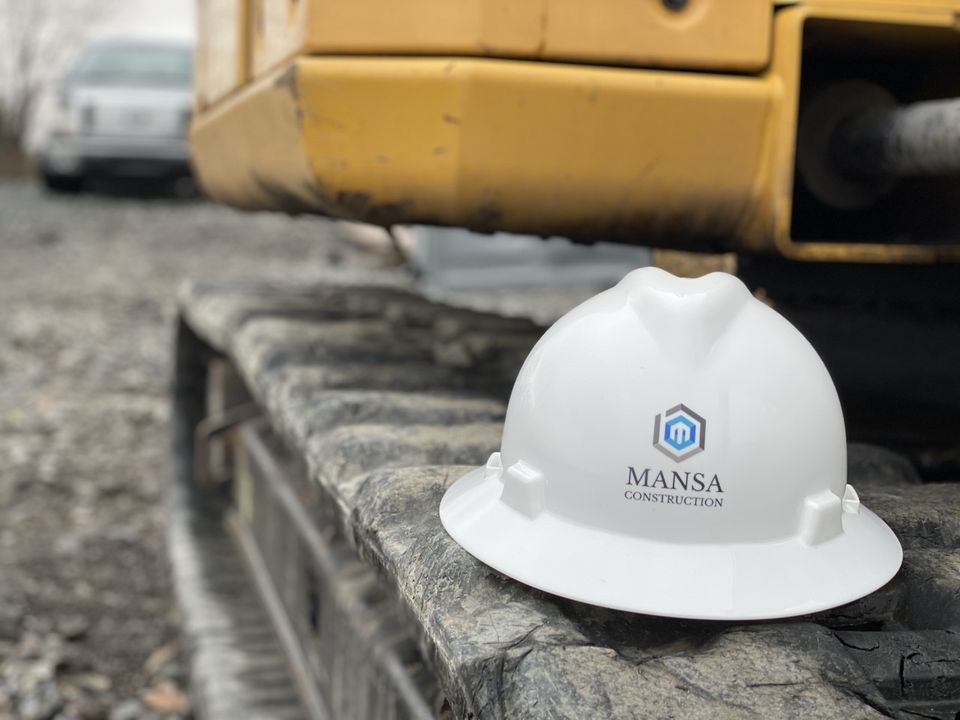Hardhat on excavator track at a Louisville construction site